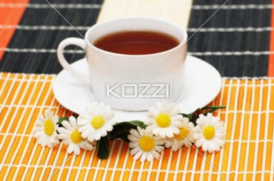 Cup Of Tea With Herbs And Daisies